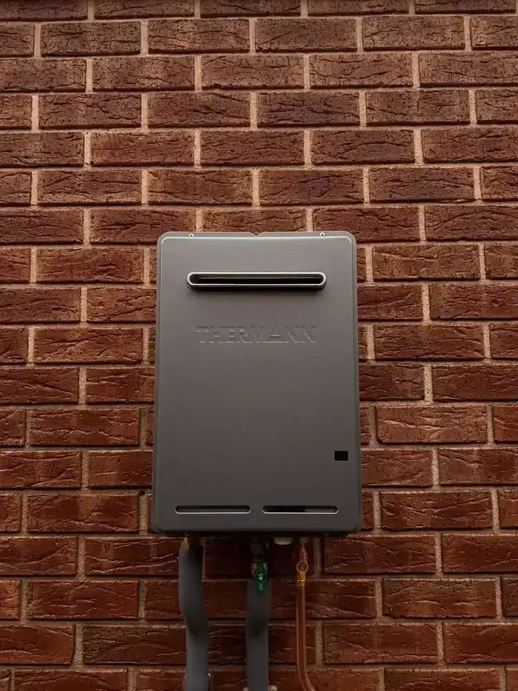 Close up of Thermann continuous flow gas hot water pipework