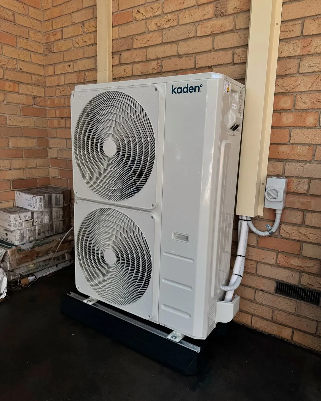 Ducted system outdoor condenser installed beside a house